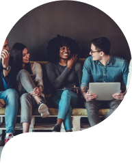 Happy diverse friends group sharing social media app news sitting holding phones, smiling multiracial young people students showing funny videos on laptop