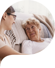 Elderly women in hospital bed with social worker