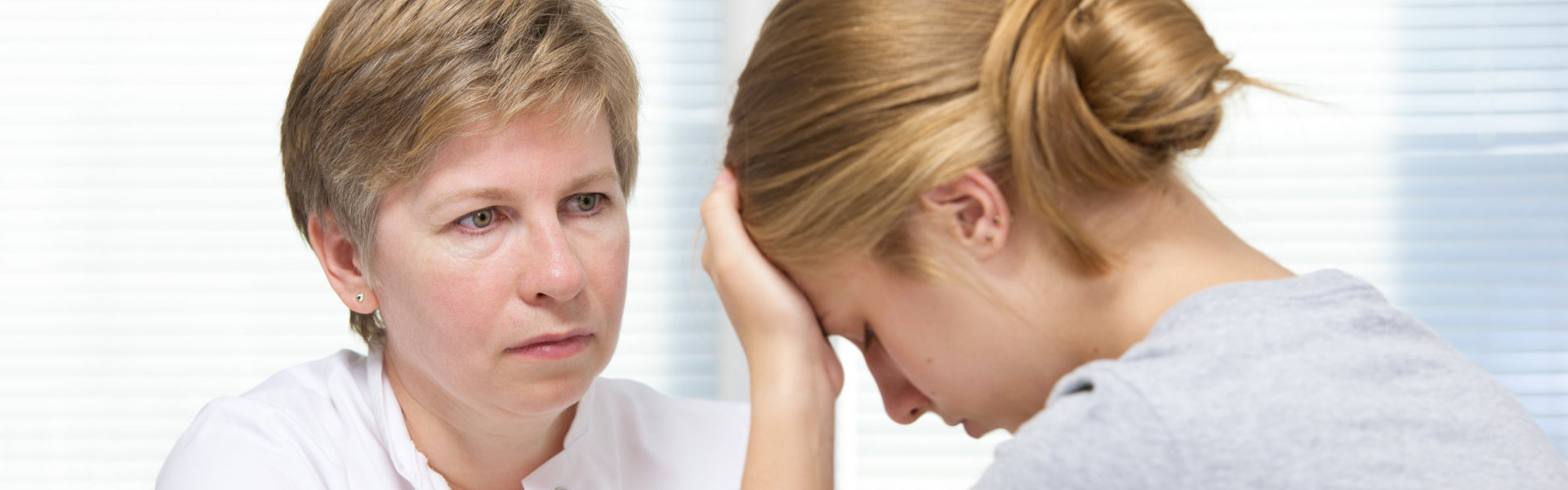 teenage girl suffering with depression in a conversation with a therapist