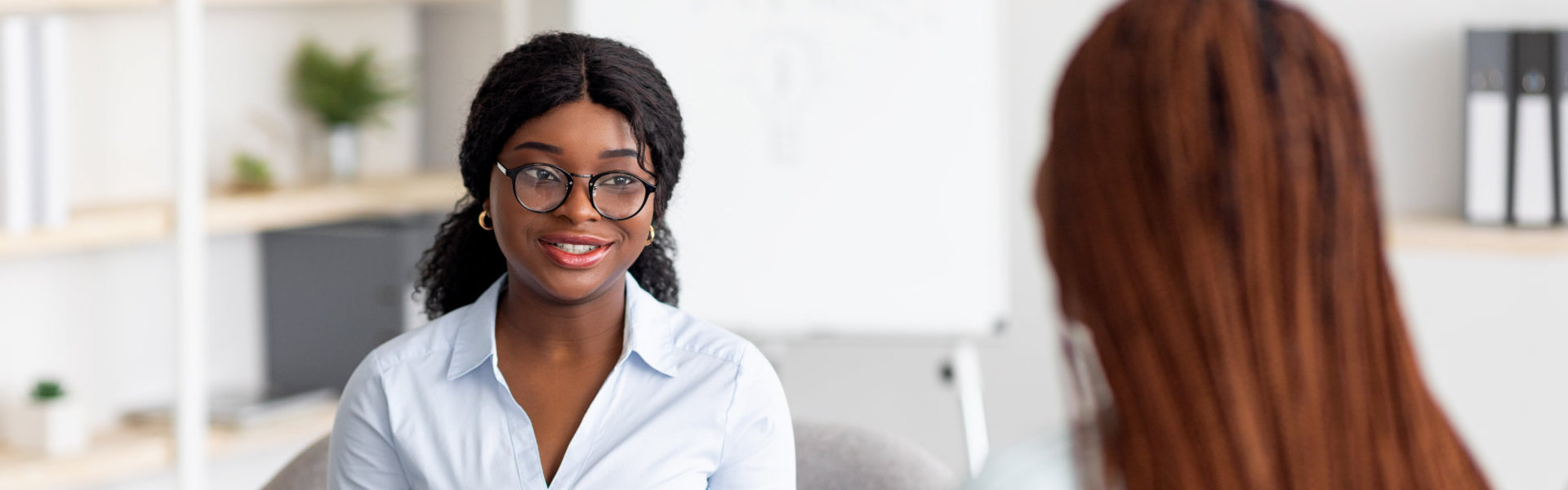 Counselor talking to woman on meeting at office