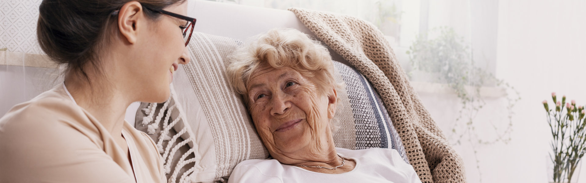 Elderly women in hospital bed with social worker