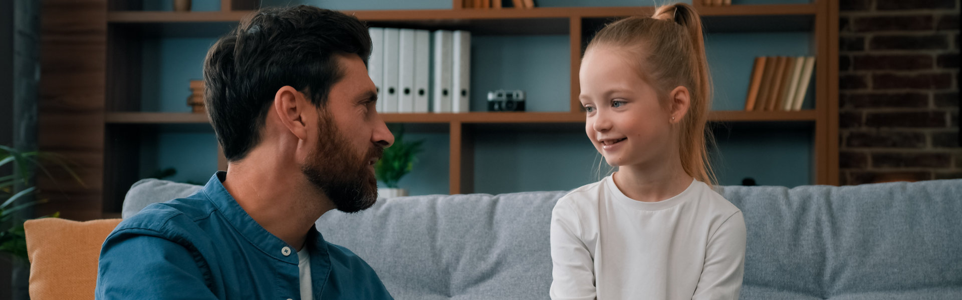 Caucasian man parent father psychologist talk to little cute kid girl teach small child of youth generation